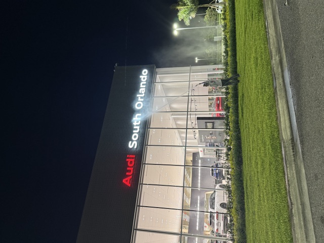 Audi South Orlando dealership exterior being washed at night